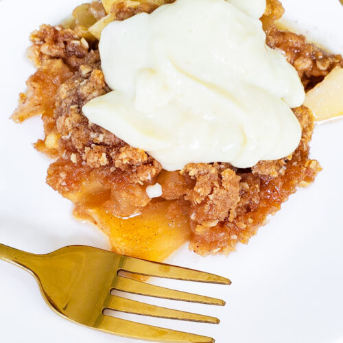 gluten-free Irish apple crumble with vanilla custard in a white baking dish